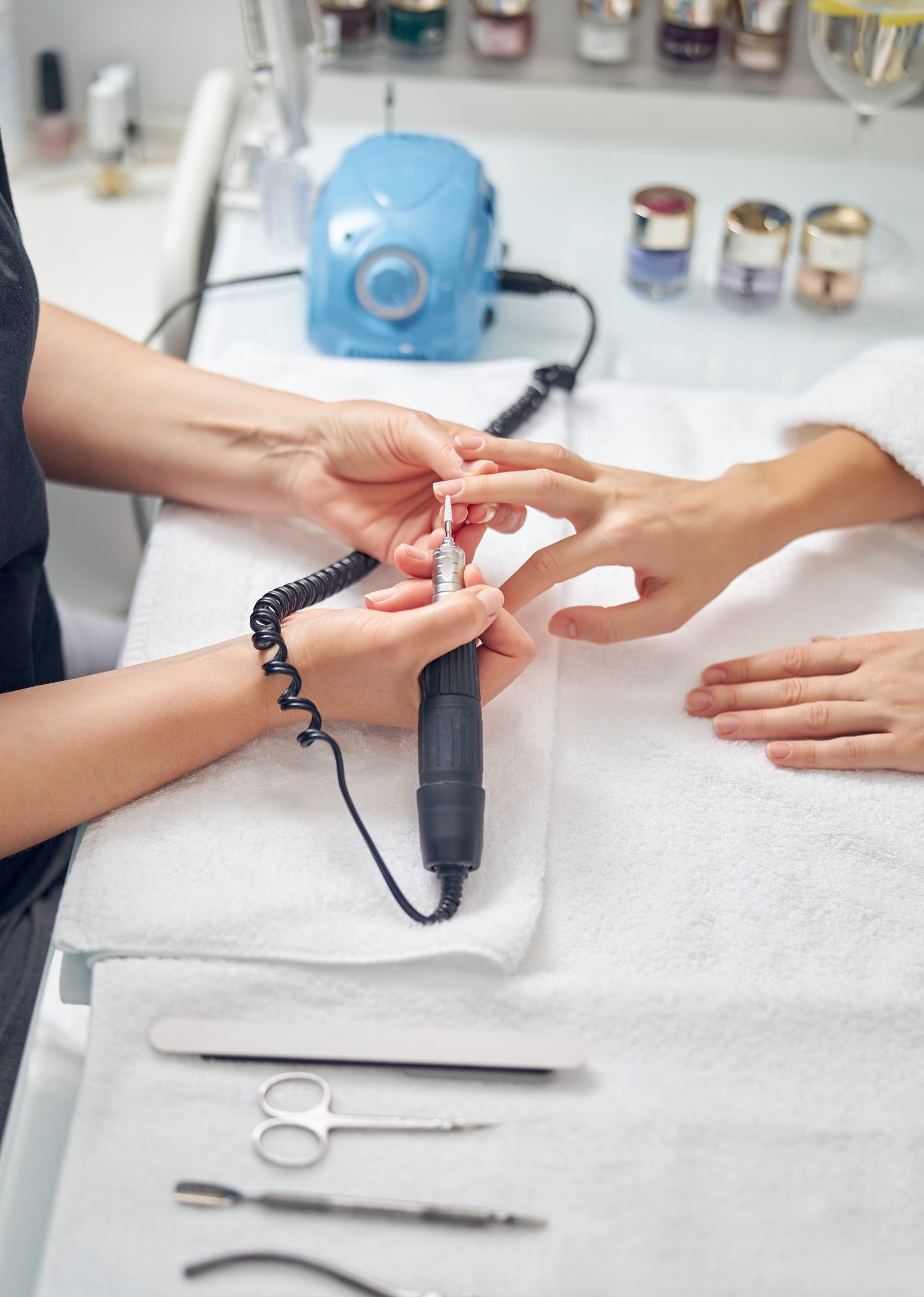 Nail artist using digital device for removing cuticle